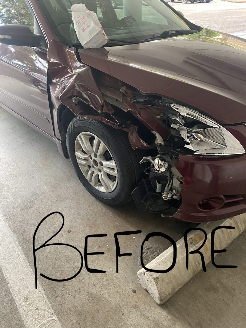 Front-end collision damage on a maroon Nissan Altima